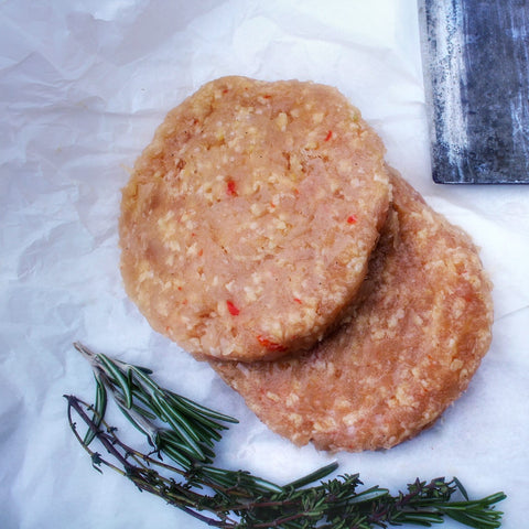 
Χειροποίητα μπιφτέκια από κόκορα ελευθέρας βοσκής, ωμά, έτοιμα για ψήσιμο.
